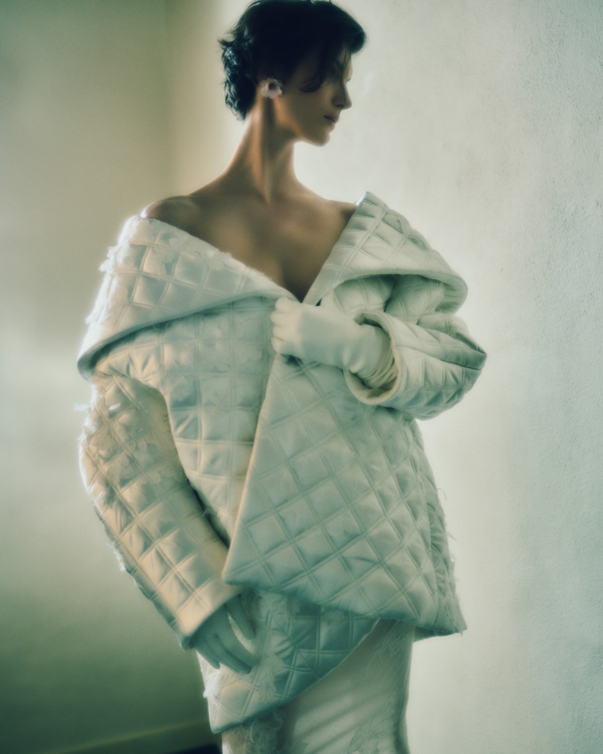 Quilted silk wool cocoon jacket with exaggerated shawl collar. Hand cut chantilly and corded lace appliques throughout. 
