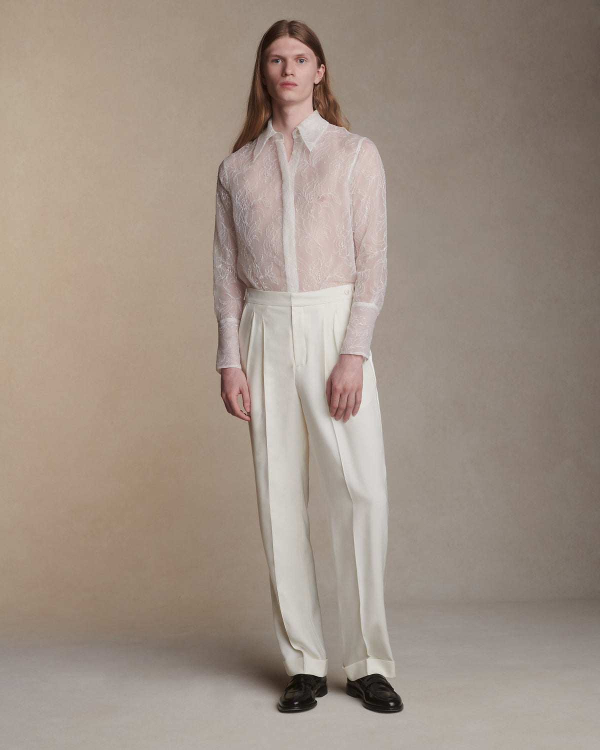 Matte silk wool straight leg pleated trouser with luminous silk wool tuxedo stripe. Shell button tab detail at side waistband. Two front side pockets. Double welt back pockets with shell button closure. Cuffed hem. Center front fly zip.