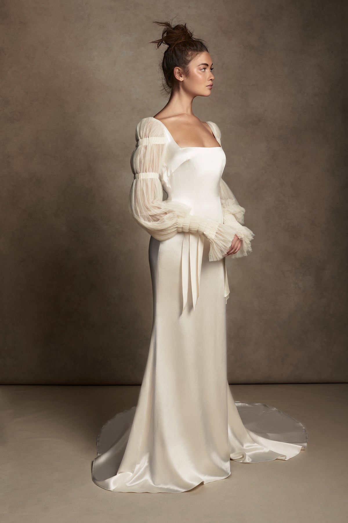 Silk Wool Satin gown with train. Pleated, delicate Tulle sleeves are gathered with Grosgrain detail.Styled with Flaired Baroque Pearl Drop Earrings 