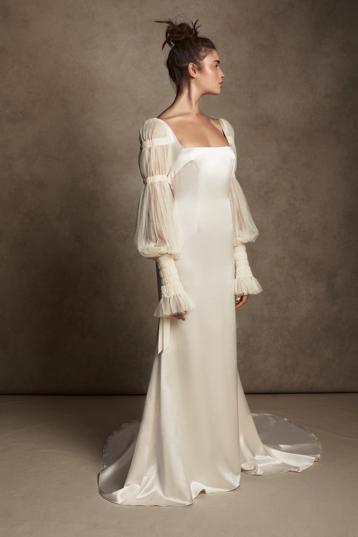 Silk Wool Satin gown with train. Pleated, delicate Tulle sleeves are gathered with Grosgrain detail.Styled with Flaired Baroque Pearl Drop Earrings 