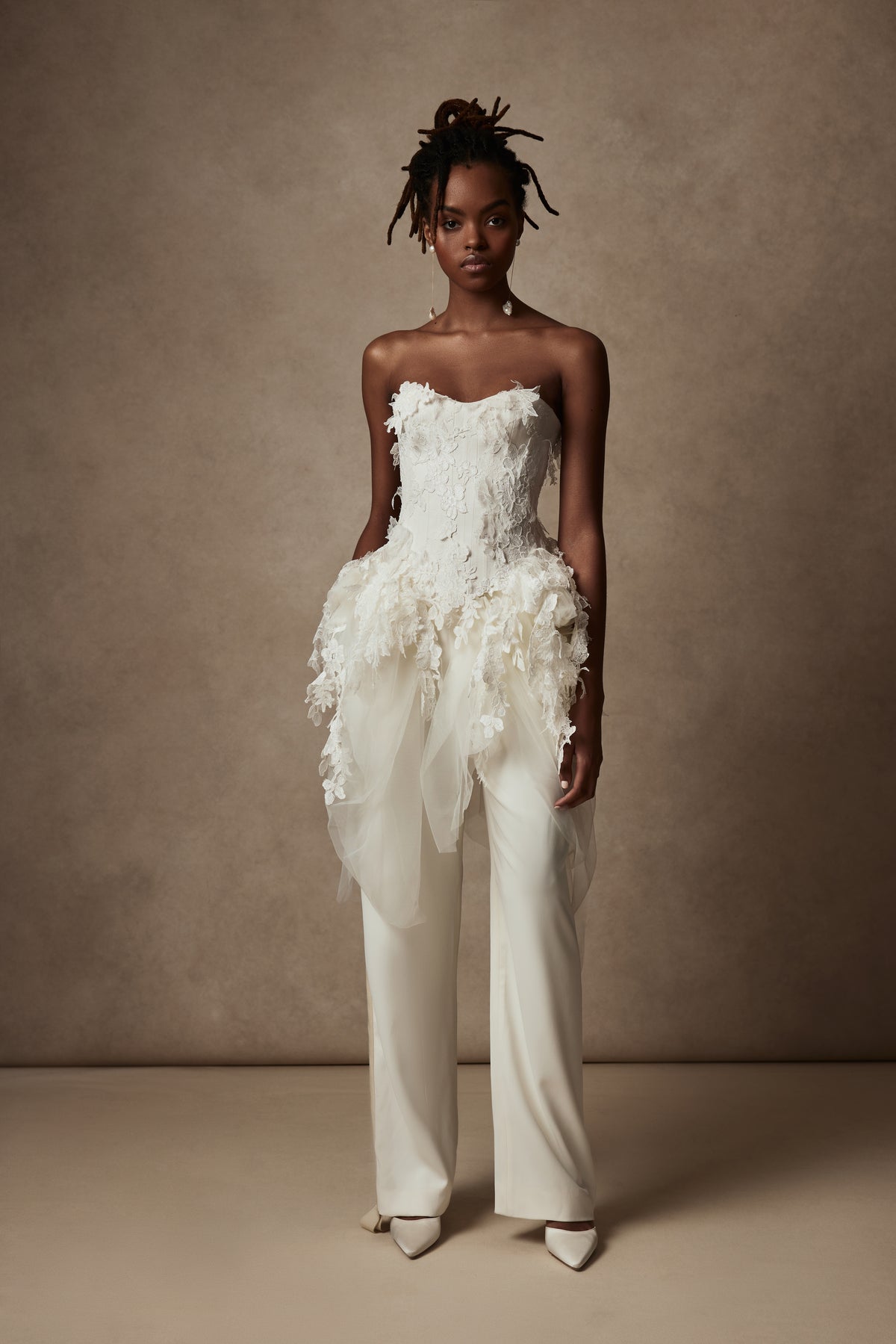 Satin twill bound, chantilly and corded lace applique bustier with draped tulle accent at hips. Back zip with hook and eye closure for security and structure.﻿