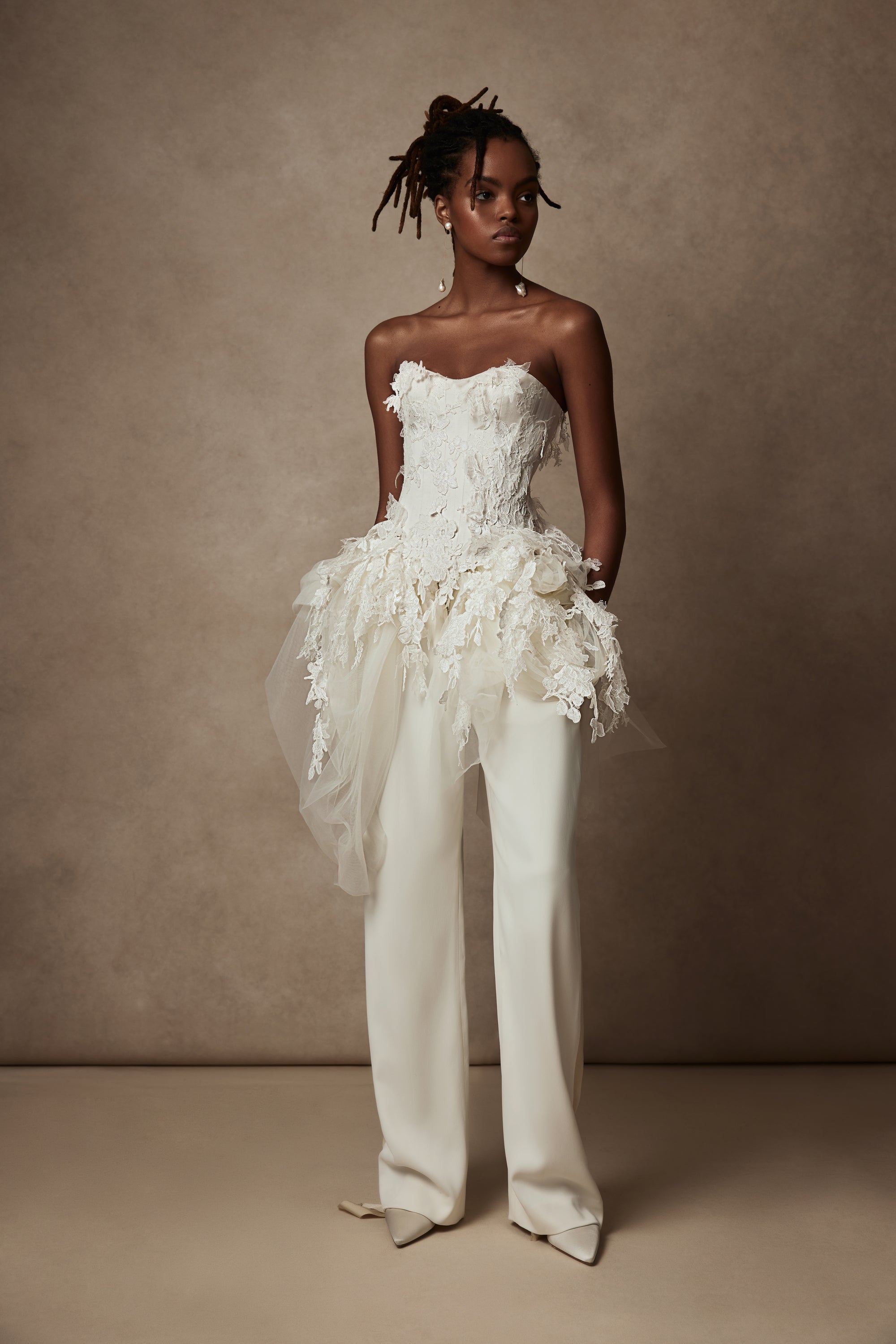 Satin twill bound, chantilly and corded lace applique bustier with draped tulle accent at hips. Back zip with hook and eye closure for security and structure.﻿