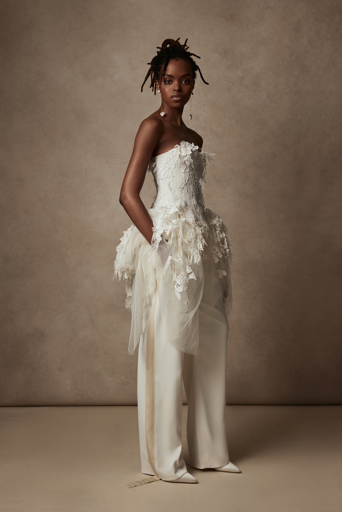 Satin twill bound, chantilly and corded lace applique bustier with draped tulle accent at hips. Back zip with hook and eye closure for security and structure.﻿