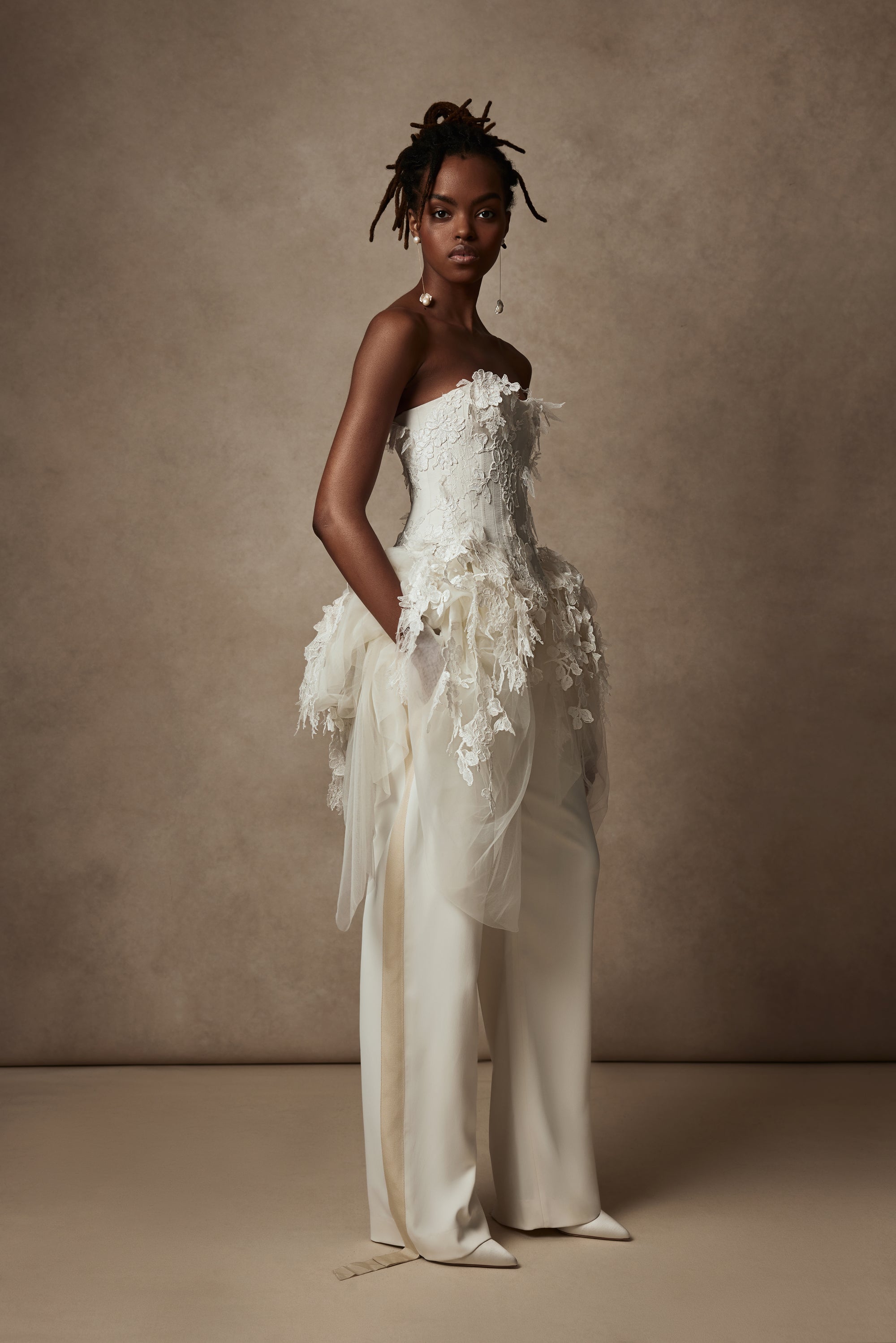 Satin twill bound, chantilly and corded lace applique bustier with draped tulle accent at hips. Back zip with hook and eye closure for security and structure.﻿