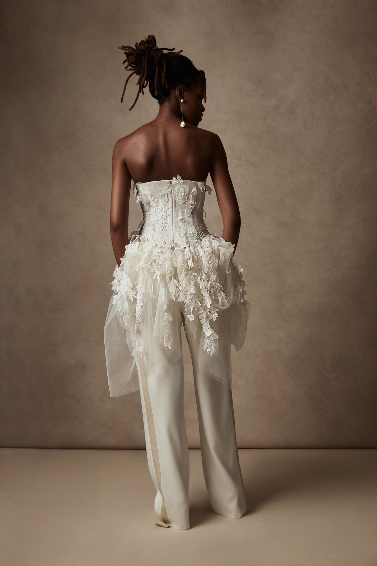 Satin twill bound, chantilly and corded lace applique bustier with draped tulle accent at hips. Back zip with hook and eye closure for security and structure.﻿