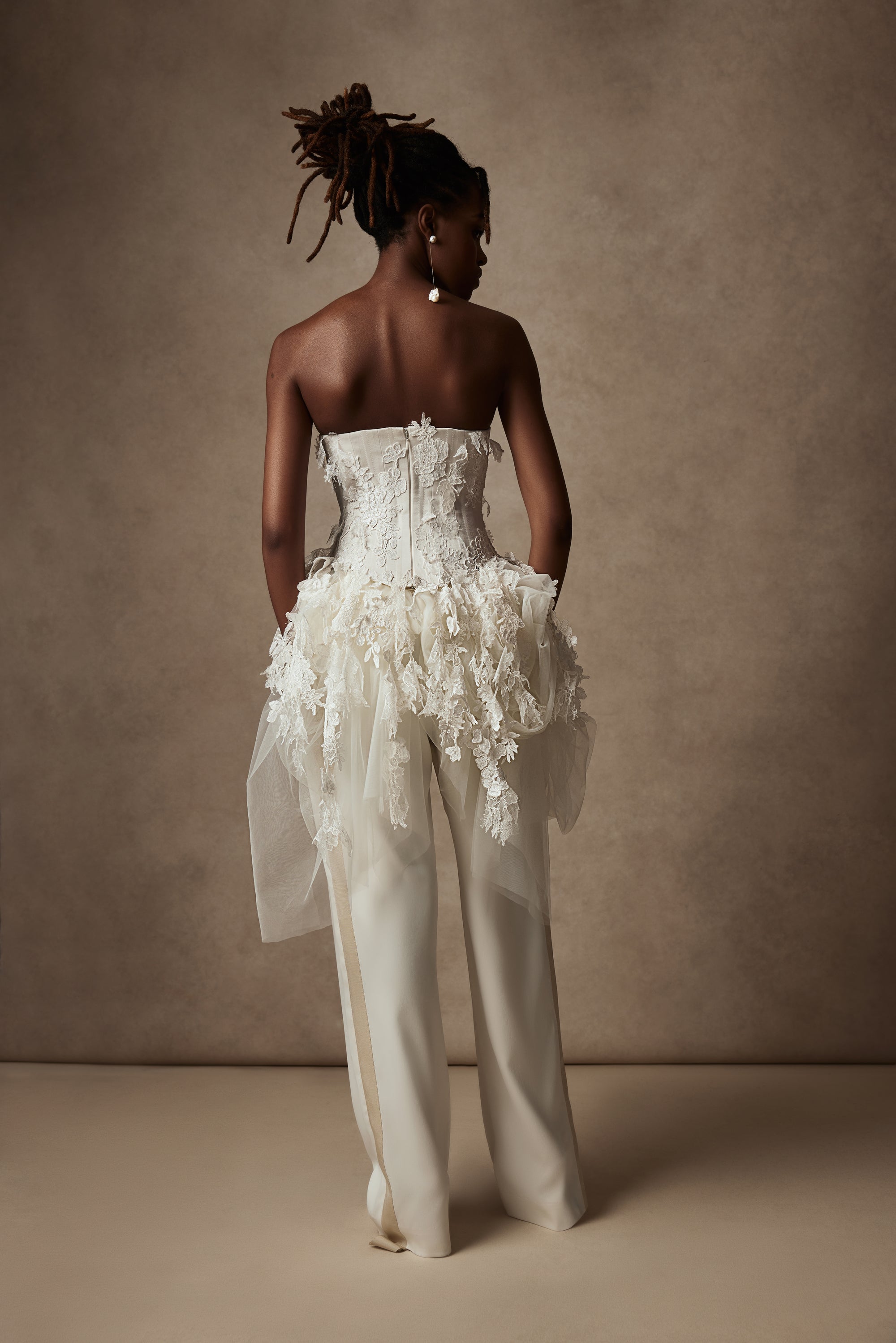 Satin twill bound, chantilly and corded lace applique bustier with draped tulle accent at hips. Back zip with hook and eye closure for security and structure.﻿