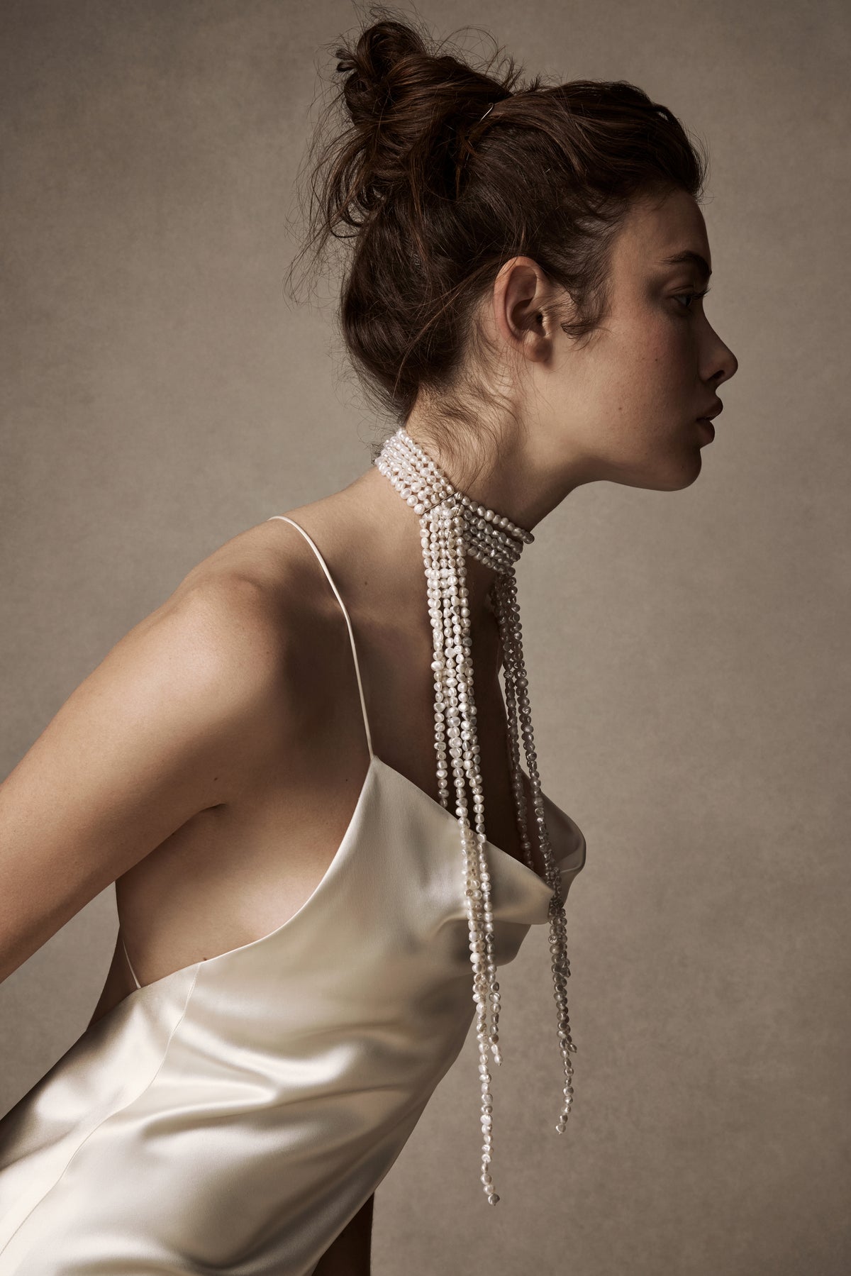 Hand knotted baroque pearls cascade from a 5 strand pearl choker secured with a silver slide lock closure at back