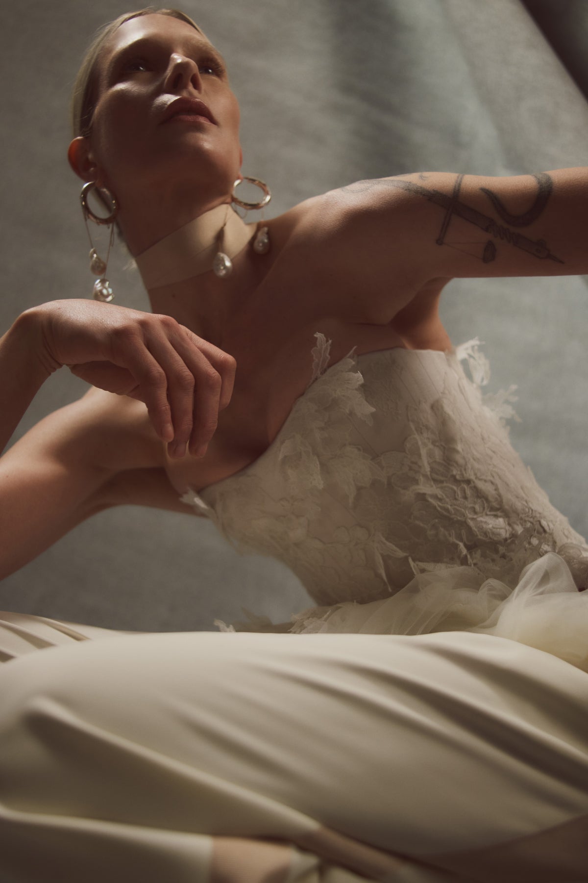 Satin twill bound, chantilly and corded lace applique bustier with draped tulle accent at hips. Back zip with hook and eye closure for security and structure.﻿