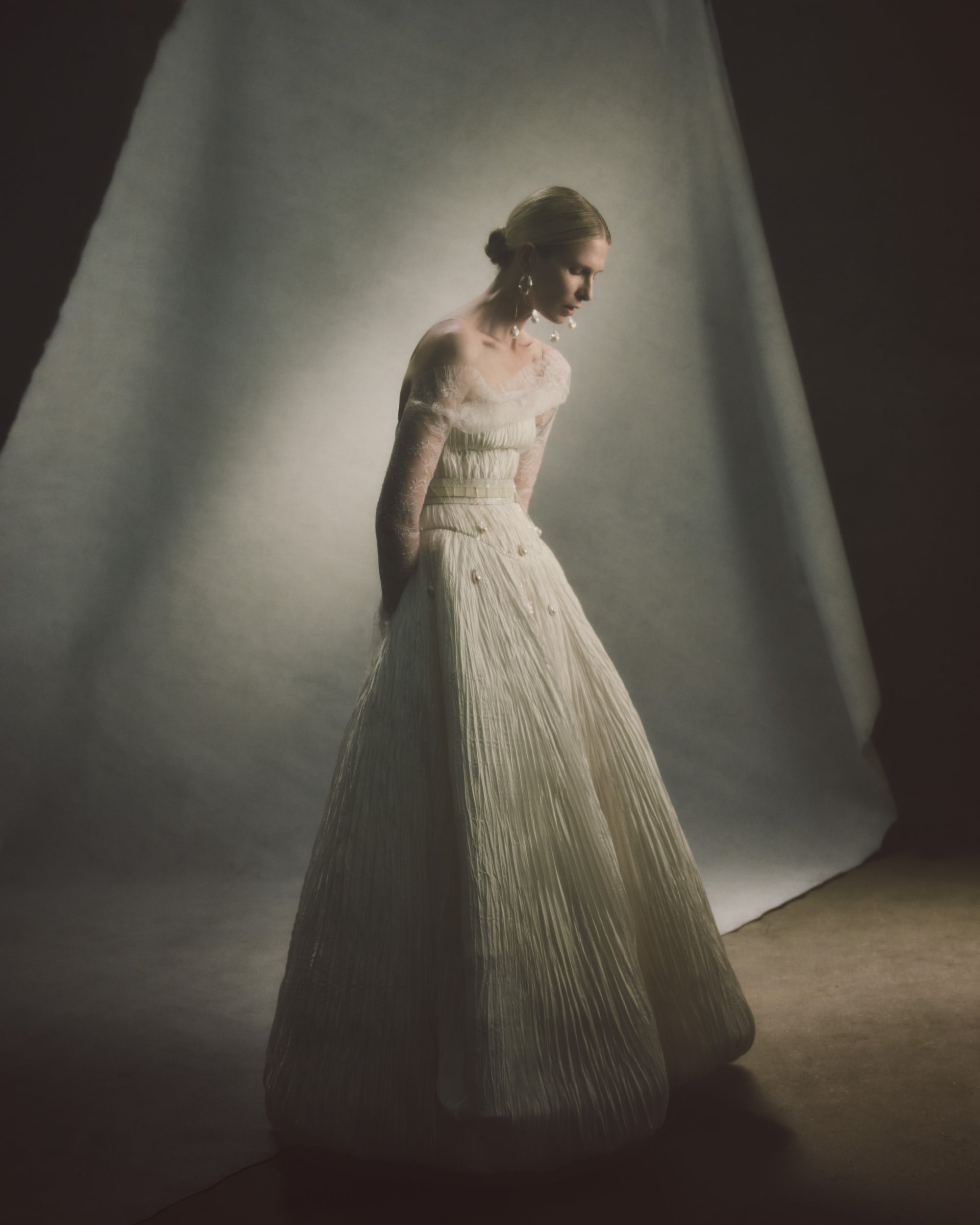 Chantilly lace reverse bolero top with long sleeves and handkerchief hemsStyled with Nadia dress, Drew &amp; Charlie gowns