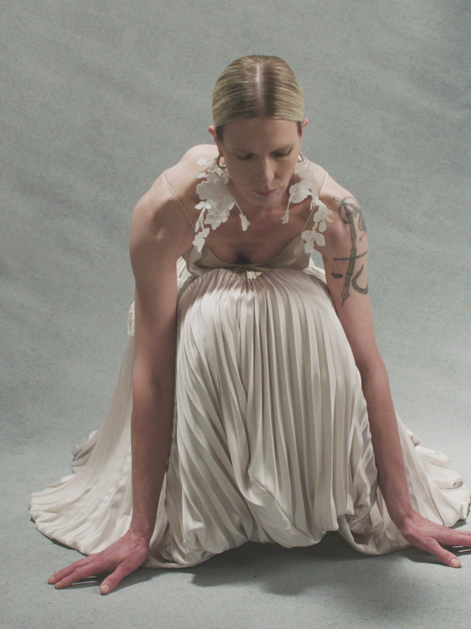 Bra: Fully structured, draped satin twill front with hand cut, hand applied corded lace with internal cups, grosgrain and four button loop closure at center back.  Skirt: Full corset with georgette trim and satin piping at seams attached to umbrella pleated skirt accented with hand cut corded lace. Hook and eye closure down center back, zipper at skirt layered over internal grosgrain waistband with three hook and bar positions. Skirt lined in organza and can can ruffle for interior construction and shaping.  