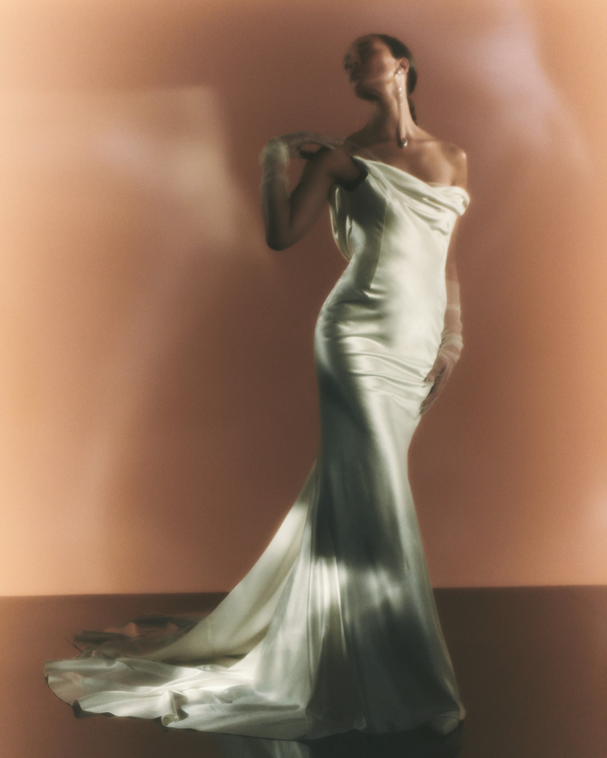 Pendulous, asymmetrical draped silk wool bias cut gown. Sweeping cowl back with detachable watteau train. Soft internal bustier with side boning, cups, and grosgrain belt with 3 hook position. Low center back zip, hook and eye closure.